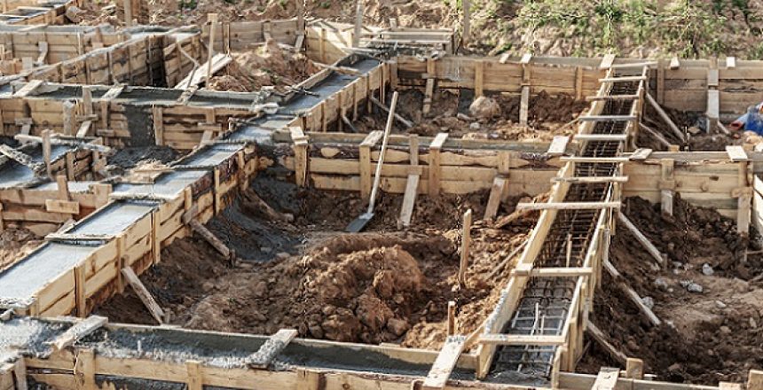 Strip foundations with formwork during the construction of a house. Reliable reinforced concrete foundation. Construction site