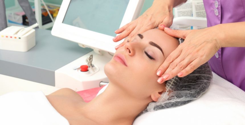 Beauty woman having cosmetic massage, facial treatment, close up.